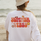 a woman wearing a white shirt that says summer vibes