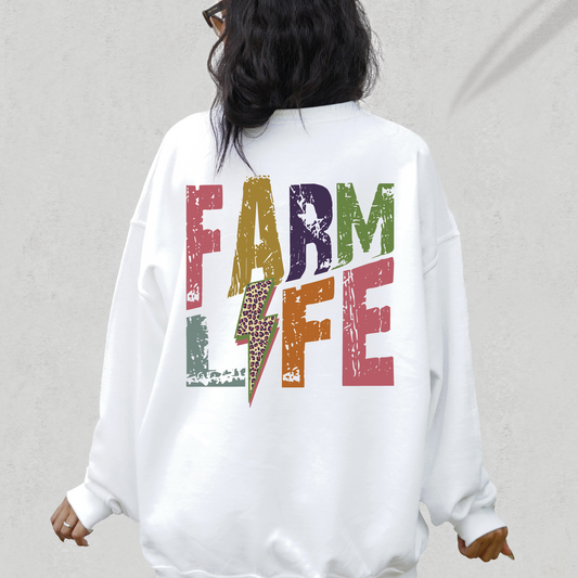 a woman wearing a white sweatshirt with the word farm life printed on it