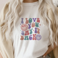 a woman wearing a t - shirt that says i love you, sky, back